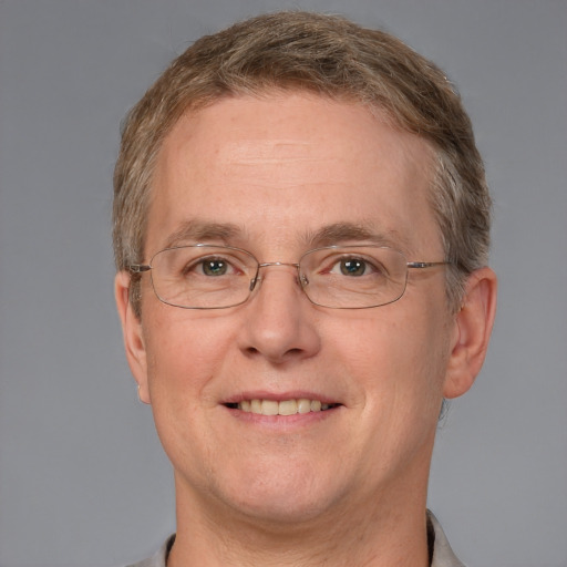 Joyful white adult male with short  brown hair and grey eyes