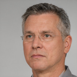 Neutral white middle-aged male with short  gray hair and brown eyes