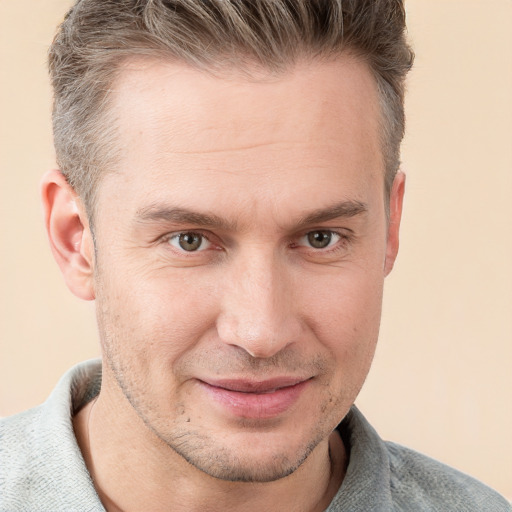 Joyful white adult male with short  brown hair and grey eyes