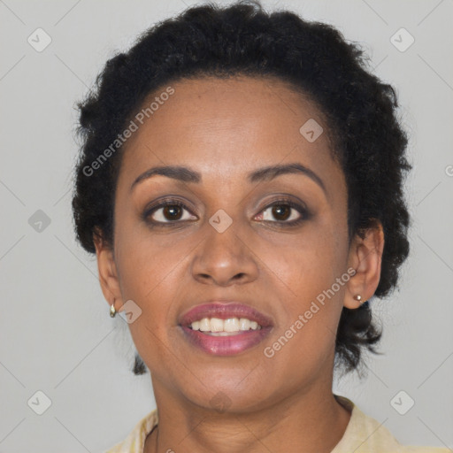 Joyful black adult female with short  brown hair and brown eyes