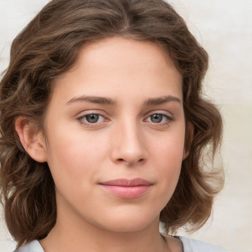 Joyful white young-adult female with medium  brown hair and green eyes