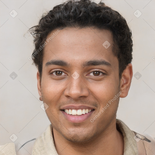 Joyful black young-adult male with short  brown hair and brown eyes