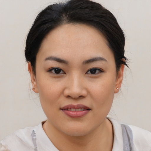 Joyful asian young-adult female with medium  black hair and brown eyes