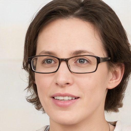 Joyful white adult female with medium  brown hair and blue eyes