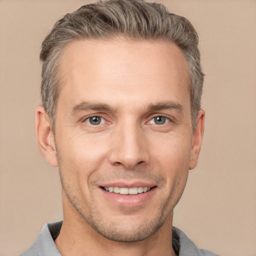 Joyful white adult male with short  brown hair and brown eyes