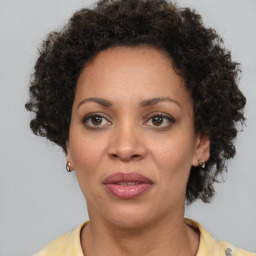 Joyful black adult female with short  brown hair and brown eyes