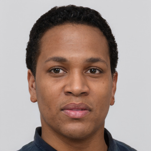 Joyful black young-adult male with short  black hair and brown eyes