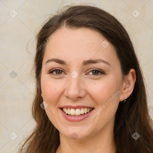 Joyful white young-adult female with long  brown hair and brown eyes