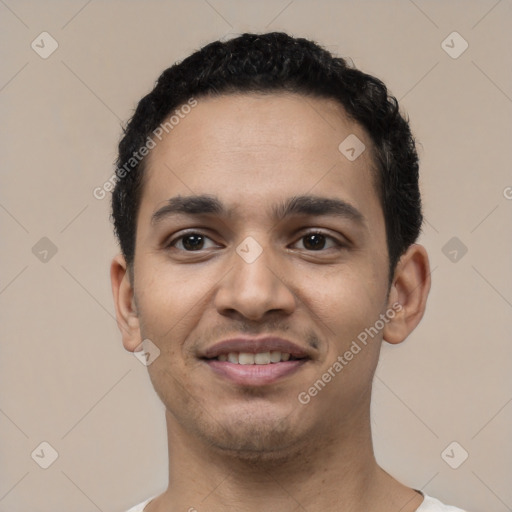 Joyful latino young-adult male with short  black hair and brown eyes