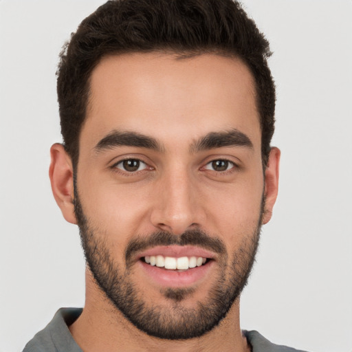 Joyful white young-adult male with short  brown hair and brown eyes