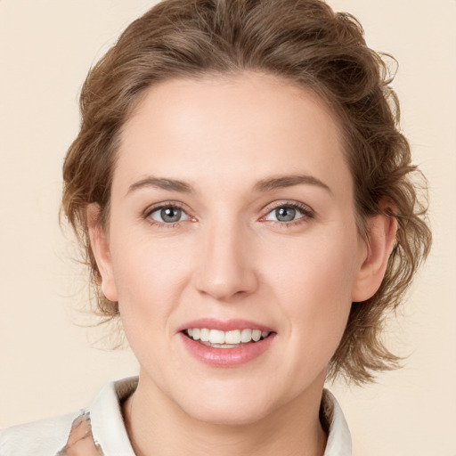 Joyful white young-adult female with medium  brown hair and green eyes