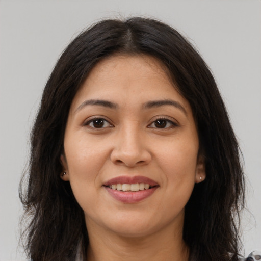 Joyful latino young-adult female with long  brown hair and brown eyes
