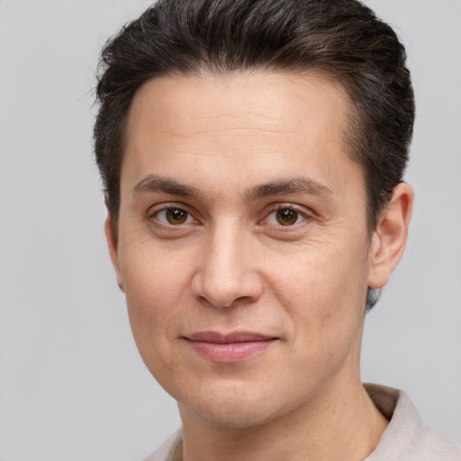 Joyful white adult male with short  brown hair and brown eyes