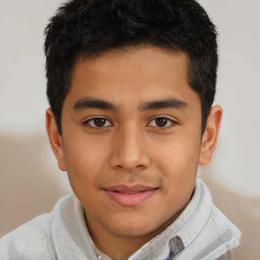 Joyful latino child male with short  brown hair and brown eyes