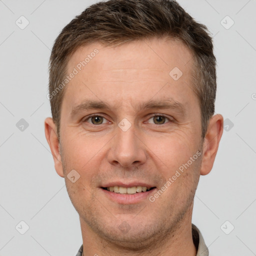 Joyful white adult male with short  brown hair and brown eyes