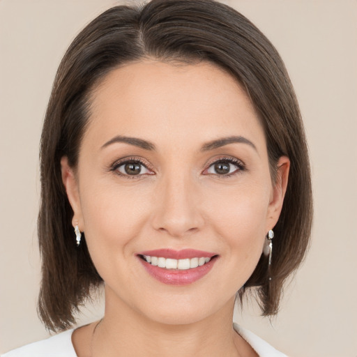 Joyful white young-adult female with medium  brown hair and brown eyes