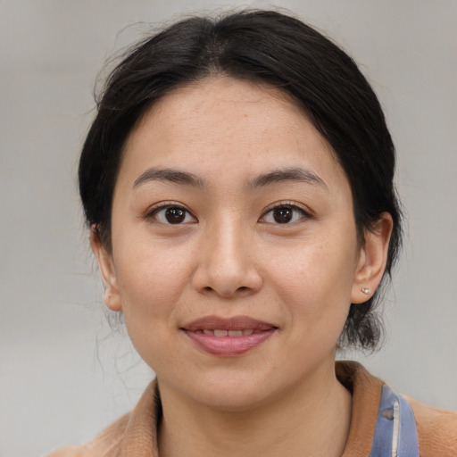 Joyful asian young-adult female with medium  brown hair and brown eyes