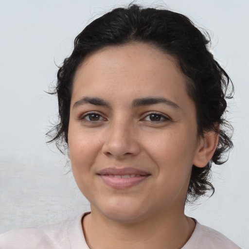 Joyful latino young-adult female with medium  brown hair and brown eyes