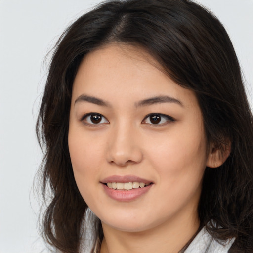 Joyful asian young-adult female with long  brown hair and brown eyes