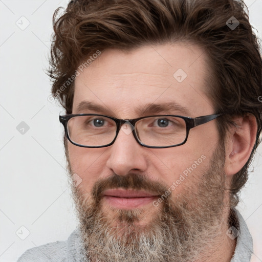 Joyful white adult male with short  brown hair and grey eyes