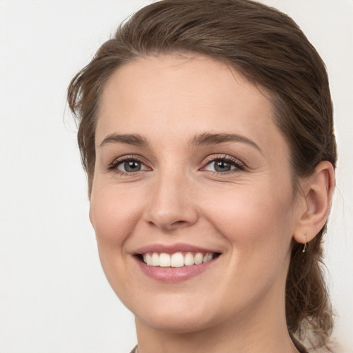 Joyful white young-adult female with long  brown hair and grey eyes