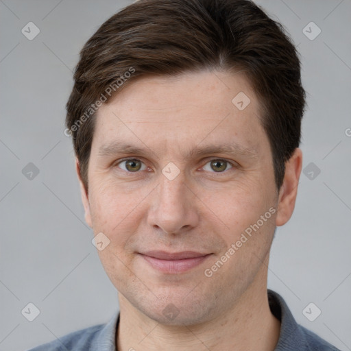 Joyful white adult male with short  brown hair and grey eyes