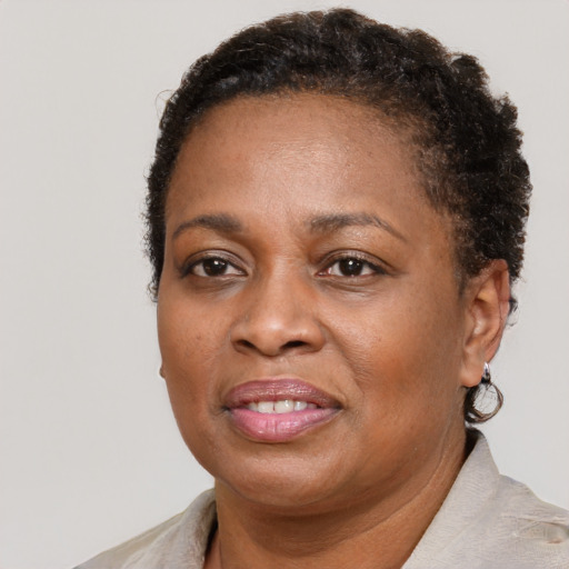 Joyful black adult female with short  brown hair and brown eyes