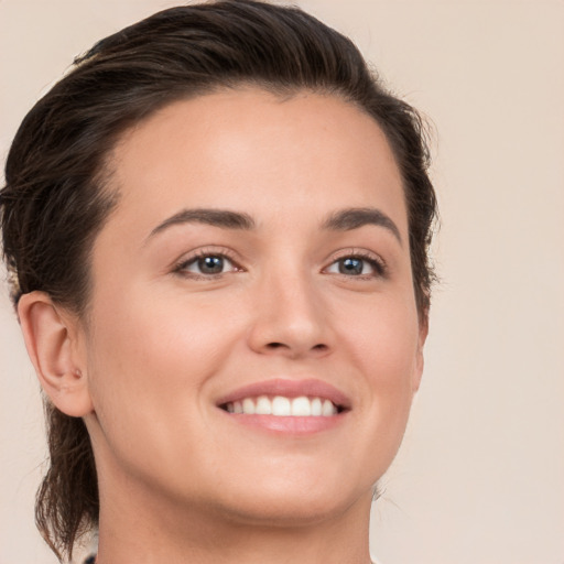 Joyful white young-adult female with medium  brown hair and brown eyes