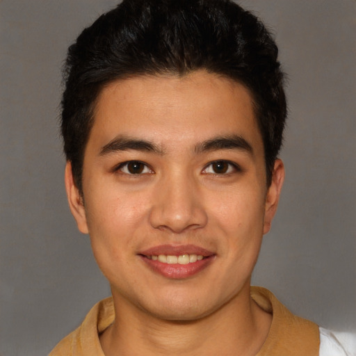 Joyful latino young-adult male with short  brown hair and brown eyes