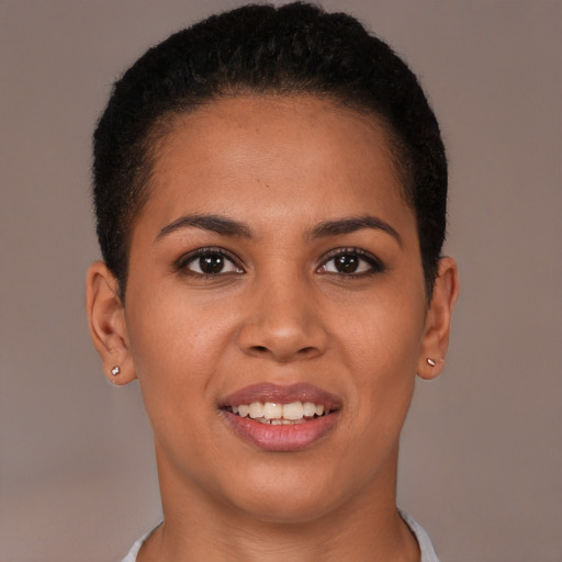 Joyful latino young-adult female with short  brown hair and brown eyes