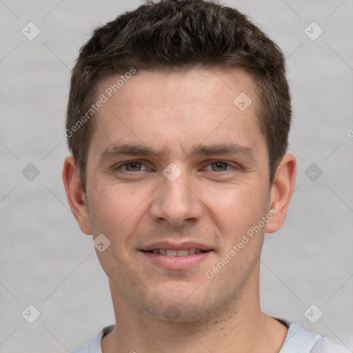 Joyful white young-adult male with short  brown hair and grey eyes