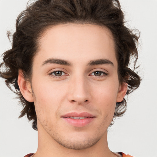 Joyful white young-adult male with medium  brown hair and brown eyes