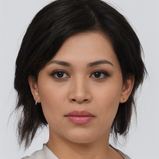 Joyful asian young-adult female with medium  black hair and brown eyes