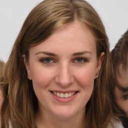 Joyful white young-adult female with long  brown hair and grey eyes