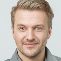 Joyful white adult male with short  brown hair and blue eyes