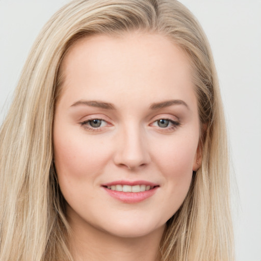 Joyful white young-adult female with long  brown hair and blue eyes