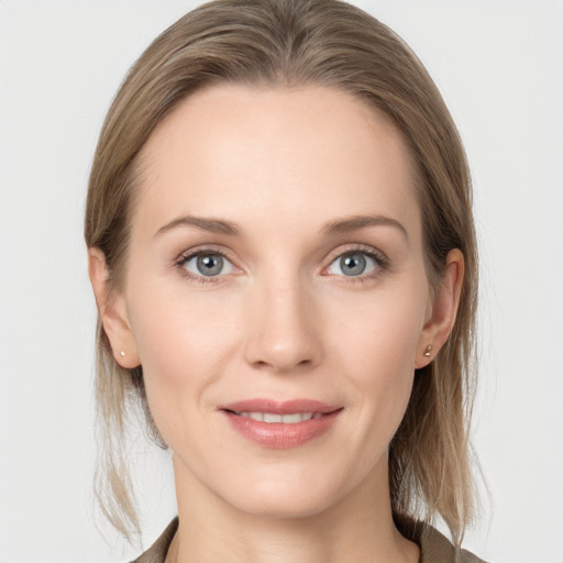 Joyful white young-adult female with medium  brown hair and blue eyes