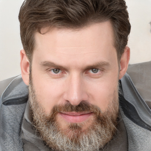 Joyful white adult male with short  brown hair and grey eyes