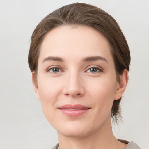 Joyful white young-adult female with short  brown hair and grey eyes