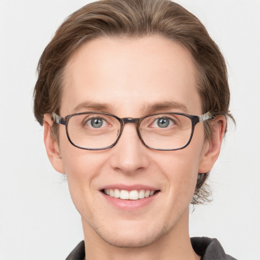 Joyful white young-adult male with medium  brown hair and blue eyes