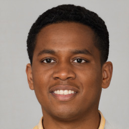 Joyful latino young-adult male with short  brown hair and brown eyes