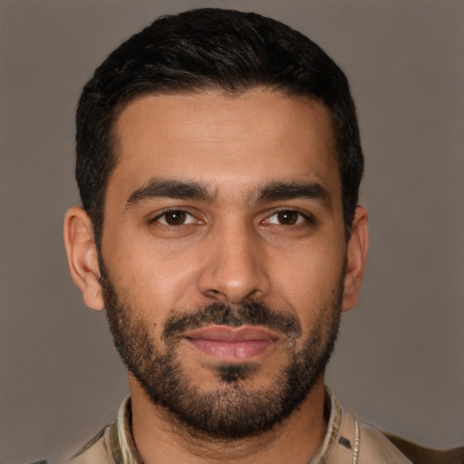 Joyful white young-adult male with short  black hair and brown eyes