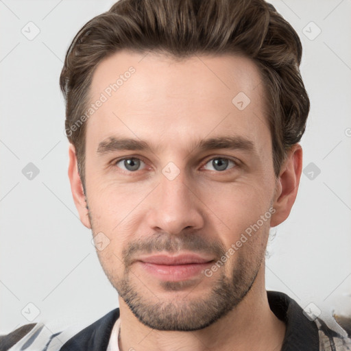 Joyful white young-adult male with short  brown hair and grey eyes