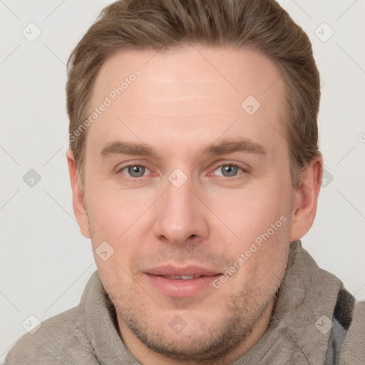 Joyful white adult male with short  brown hair and grey eyes