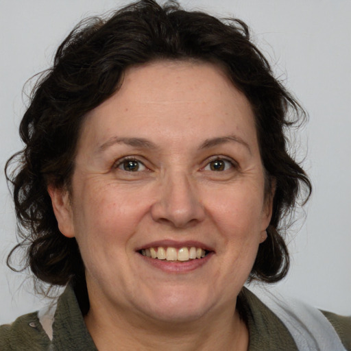 Joyful white adult female with medium  brown hair and brown eyes