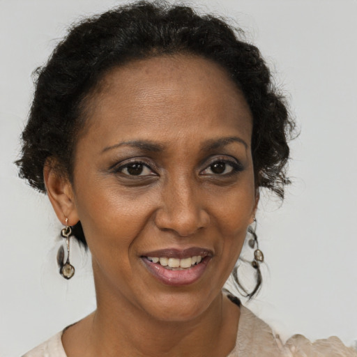 Joyful black adult female with short  brown hair and brown eyes