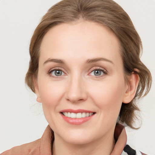 Joyful white young-adult female with medium  brown hair and blue eyes