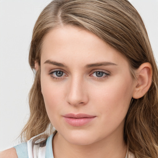 Joyful white young-adult female with long  brown hair and blue eyes