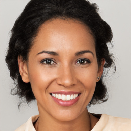 Joyful latino young-adult female with medium  brown hair and brown eyes