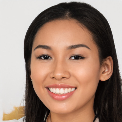 Joyful latino young-adult female with long  black hair and brown eyes